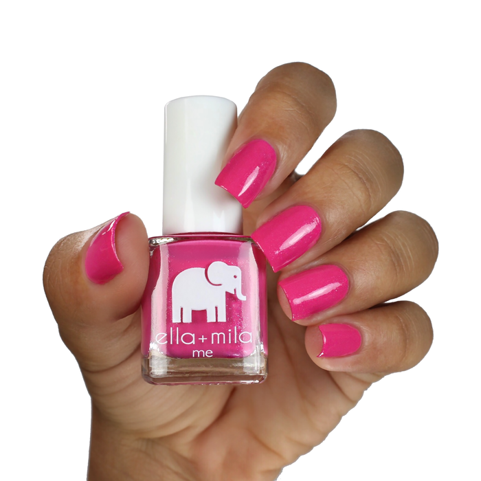 Pretty Princess hot pink nail polish on a deep skin tone, hand holding the bottle
