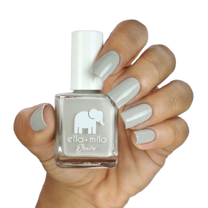 Sway With Me light grey nail polish on a medium skin tone, hand holding the bottle