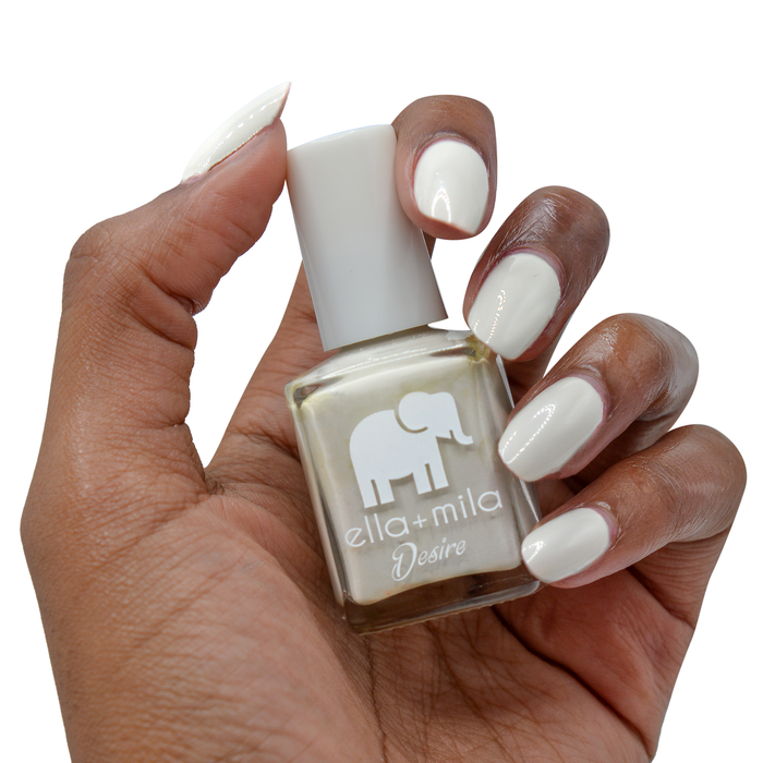 Sway With Me neutral grey nail polish on a deep skin tone, hand holding the bottle