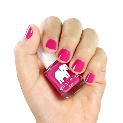 Sweet Tart summer hot pink nail polish manicure on a light skin tone with the bottle