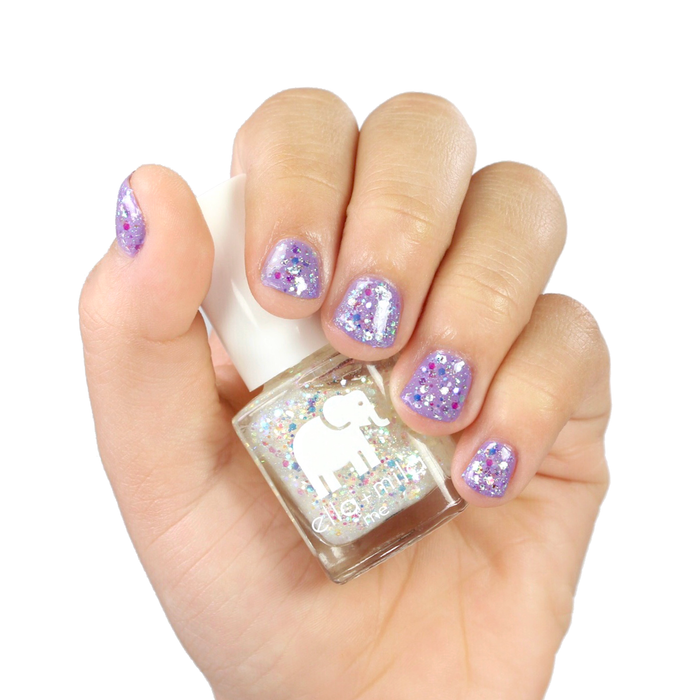 Twinkle Twinkle glitter nail polish layered over lavender, hand holding the bottle