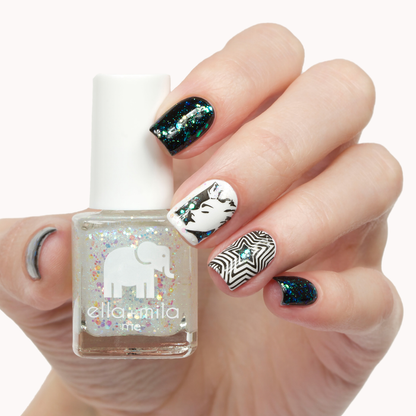 Twinkle Twinkle glitter nail polish with black and white patterned accent nails