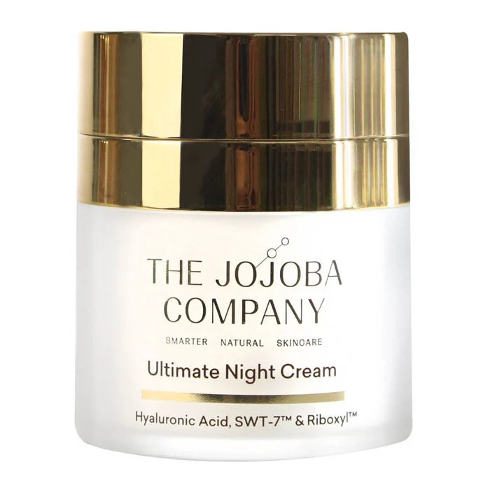 White jar of Ultimate Night Cream from The Jojoba Company with a gold lid on a white background