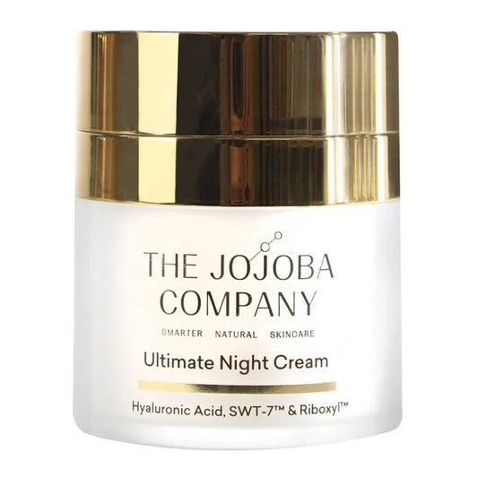 White jar of Ultimate Night Cream from The Jojoba Company with a gold lid on a white background