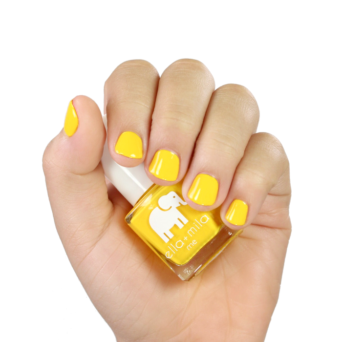 Wheels on the Bus sunshine yellow nail polish manicure on a light skin tone with the bottle